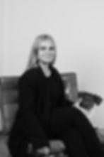 A black and white portrait of Ronja Klinger with her dog, she is the assistant of finance at peax.