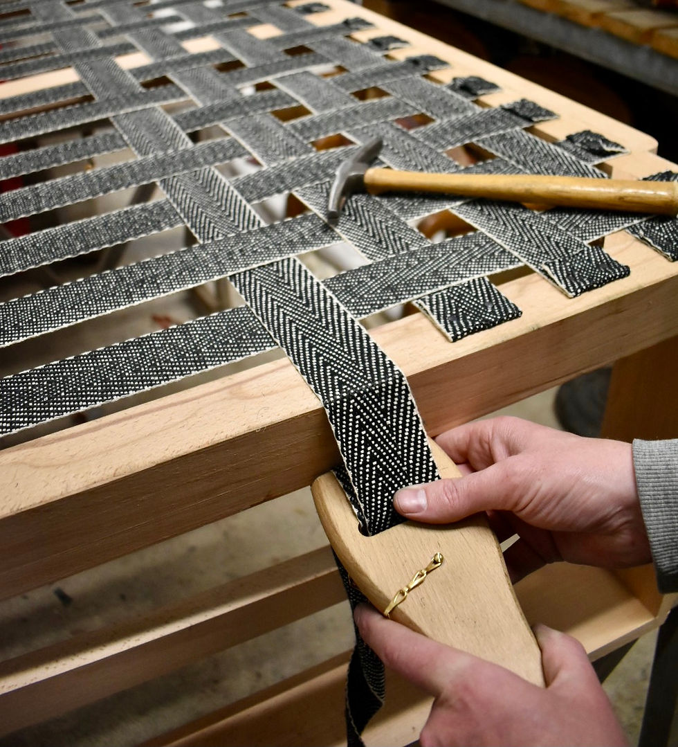 Close-up view of a restored antique chair with natural fabric and wooden frame