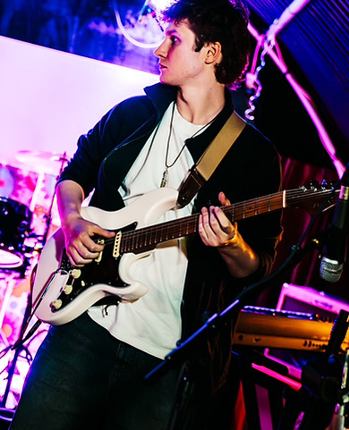 Benji playing the guitar on the stage
