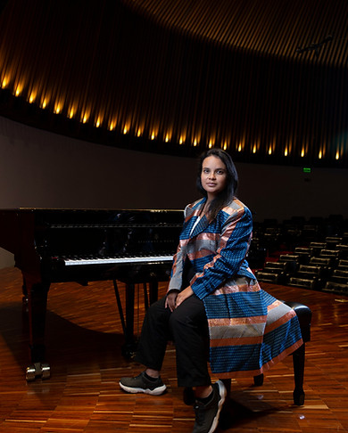 Eliana Echeverry in front of a piano
