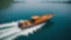 Eye-level view of a traditional propeller boat cruising on smooth waters