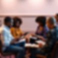bible study setting with hints of purples, lavender, black male and female people, along w