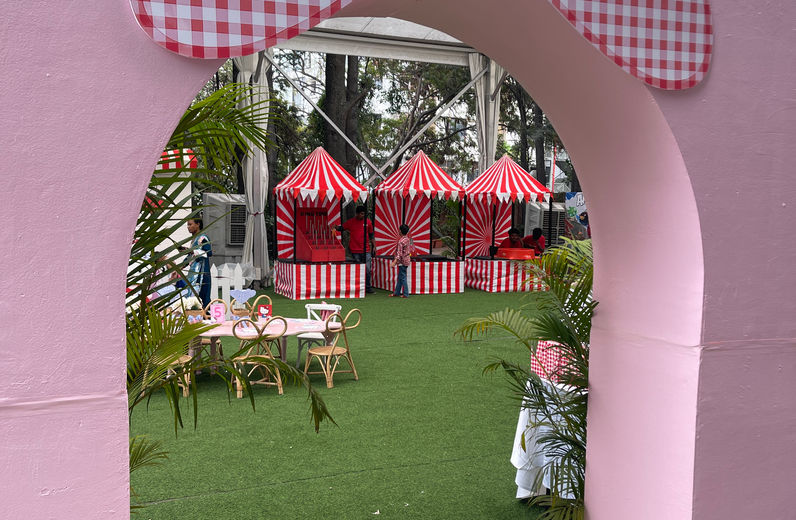 Pink bow entrance to Hello Kitty birthday setup with carnival game stalls in Bangalore