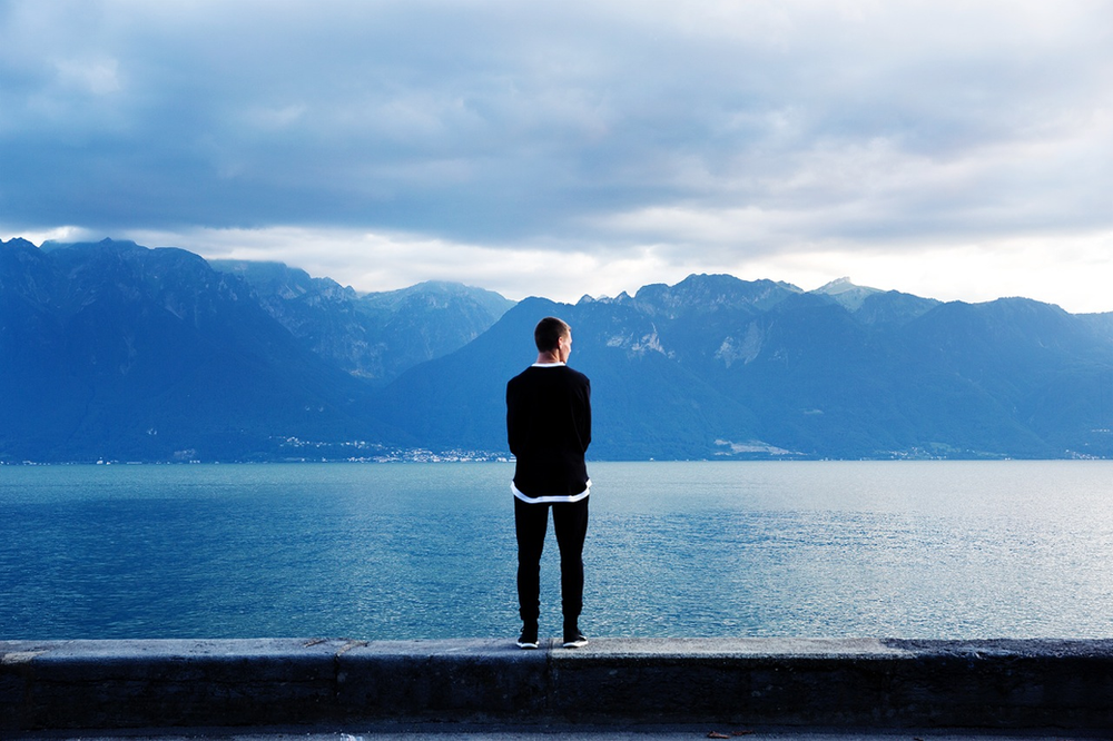 Man overlooking lake thinking about his life