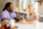 african-social-worker-helping-senior-woman.jpg