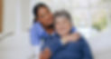 senior-woman-nurse-hug-sofa-retirement-home-caregiver-support-smiling-love-friendly-empath