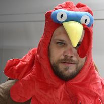Man in red chicken costume