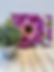 Floral design on Blush Bloom Cutting Board, standing on a wooden surface.