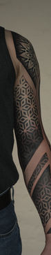 Man with geometric tattoo sleeve. Blackwork and pattern tattoos.