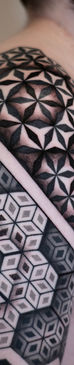 Man with geometric pattern tattoo sleeve.