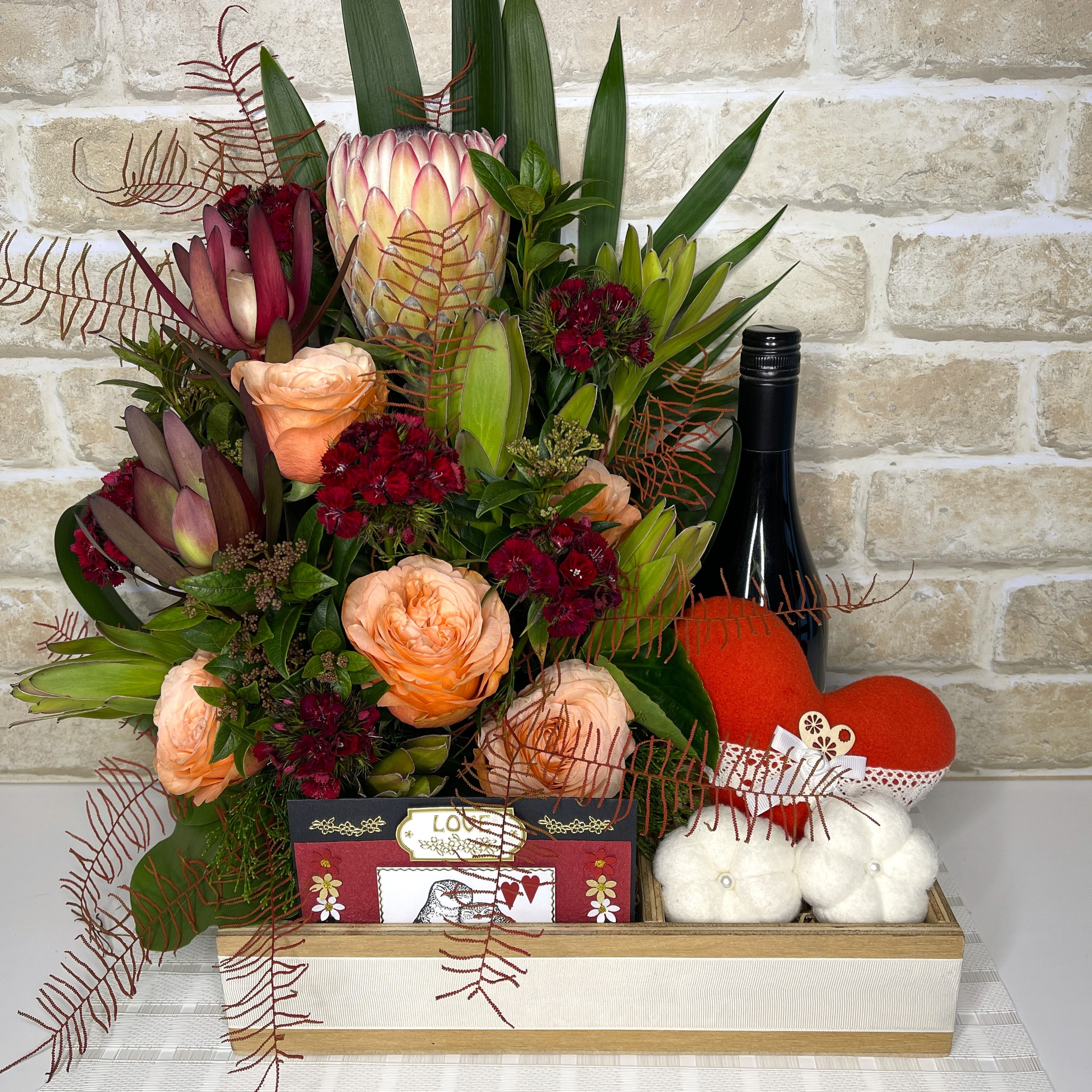 Proposal, engagement or wedding gift box with flowers and handmade red heart keepsake