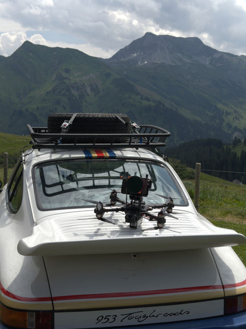 fpv drone on a porsche in the mountains