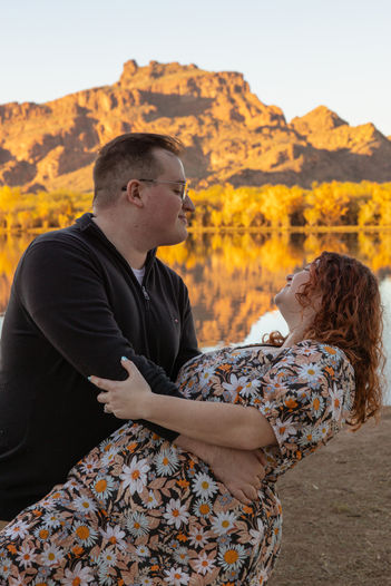 a man and a woman, the man is dipping the woman and they are smiling at each other
