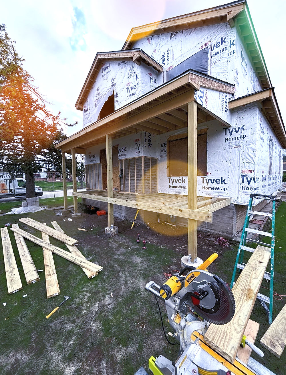 House under construction with framing for a new wooden deck.