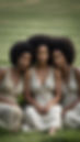 CREATE A REALISTIC PHOTO OF 3 BLACK WOMEN SITTING ON THE GRASS IN A FIELD. . THEY EACH HAV