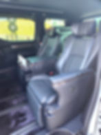 Interior of the luxury SIMOSE limousine with fully reclining leather seats, resembling first-class airline seating.