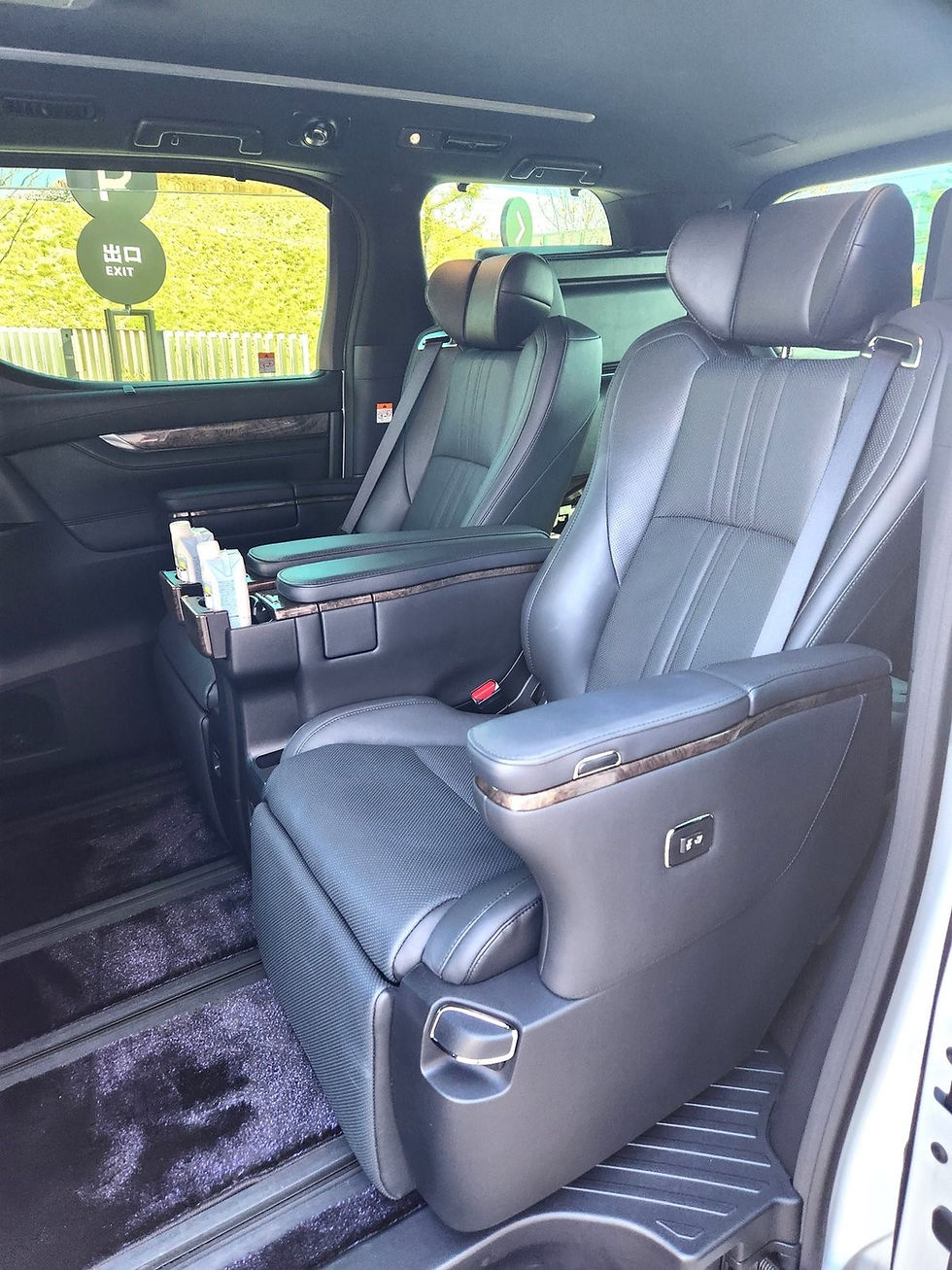 Interior of the luxury SIMOSE limousine with fully reclining leather seats, resembling first-class airline seating.