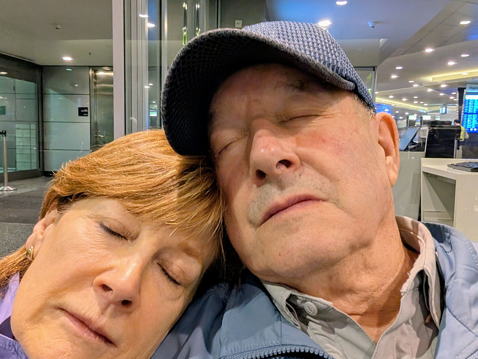 Pam and Doug asleep together in an airport terminal
