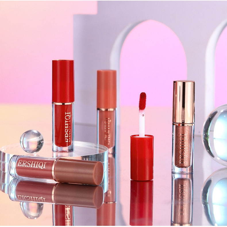 Assorted liquid lip gloss tubes, red and nude