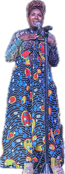 Adora Aiza sings soulfully on stage, wearing a stunning African print dress.