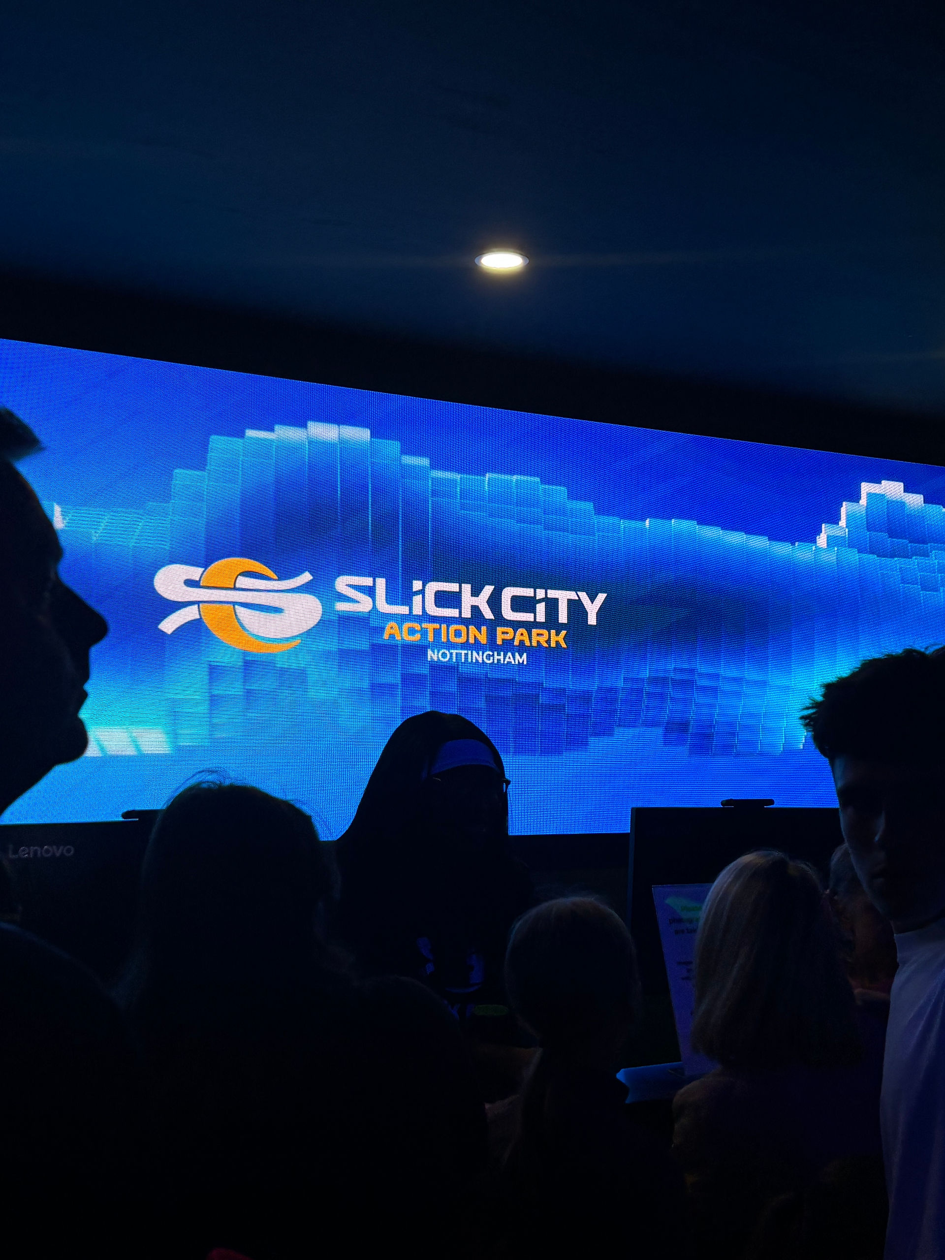 Digital wall screen with Slick City branding