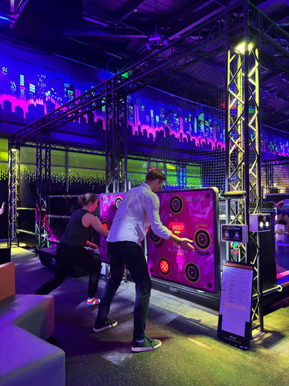 Two people playing side by side on interactive reaction walls