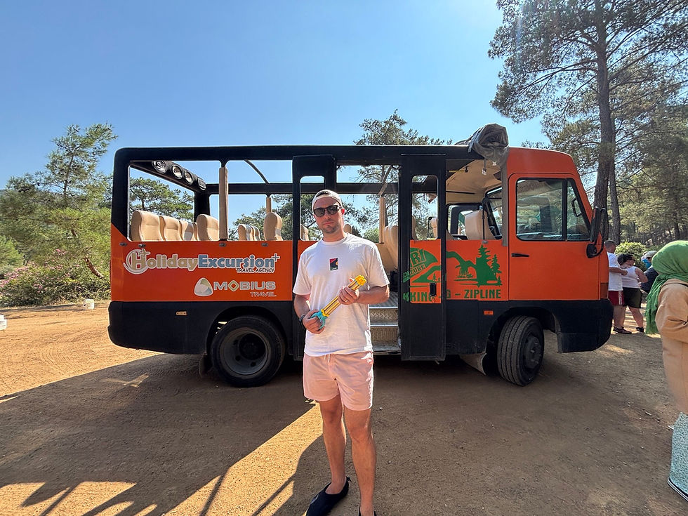 Robin Mills stood infront of truck holding water gun