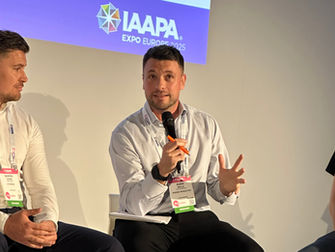Robin speaking into microphone at exhibition panel