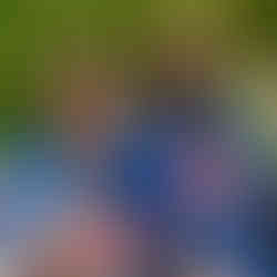 young woman sitting on a bench next to another woman. both wearing blue shirts that say heroes unite