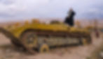 woman stands on a tank in afghanistan