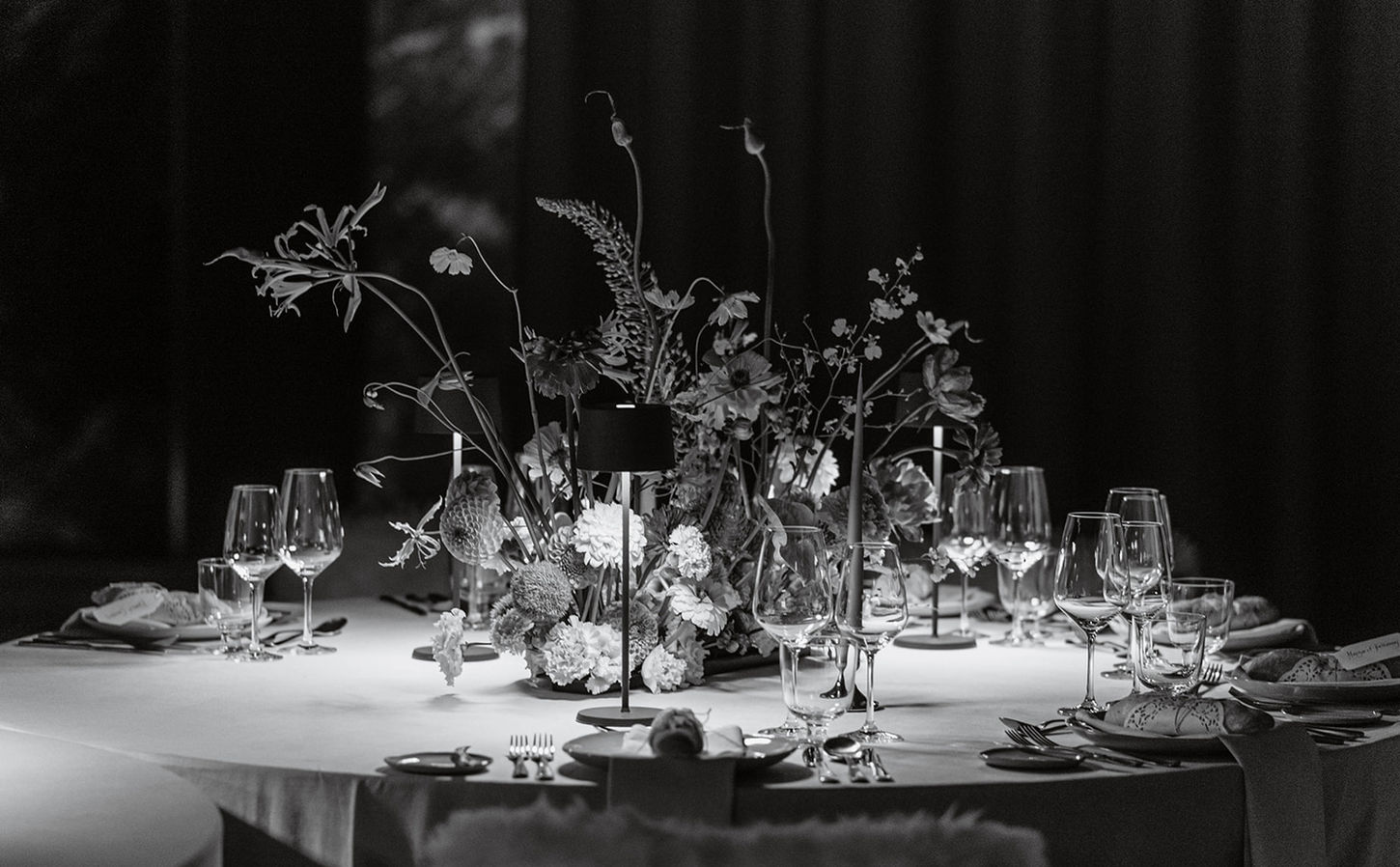 Elegant floral wedding centerpiece with candles in Crans Montana.