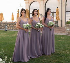 Bridesmaids in lilac holding white bouquets