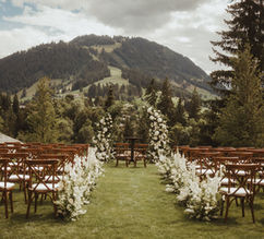 Ceremony aisle lined with white delphinium, framed by pines and mountains
