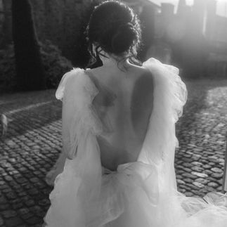 Bride photographed from behind, with a bridal gown Millia London