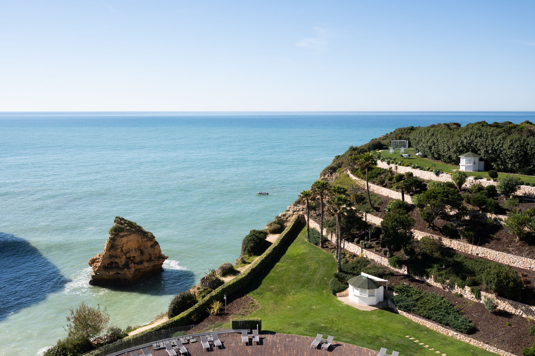 The Algarve coastline curving away beneath the cliffs