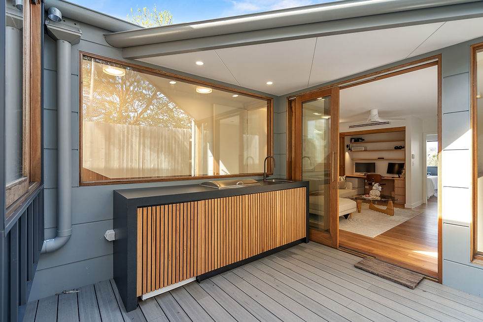 Finished deck and outdoor kitchen beside glazed doors in a terrace rear extension, Annandale