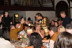 Auctioneer George Franco in the crowd congratulating the auction winner