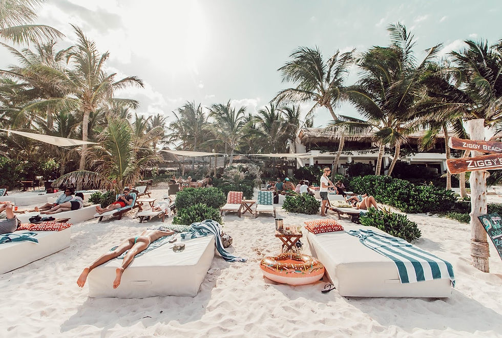 woman tanning with a hangover on a beach bed at Ziggy's beach club, Tulum