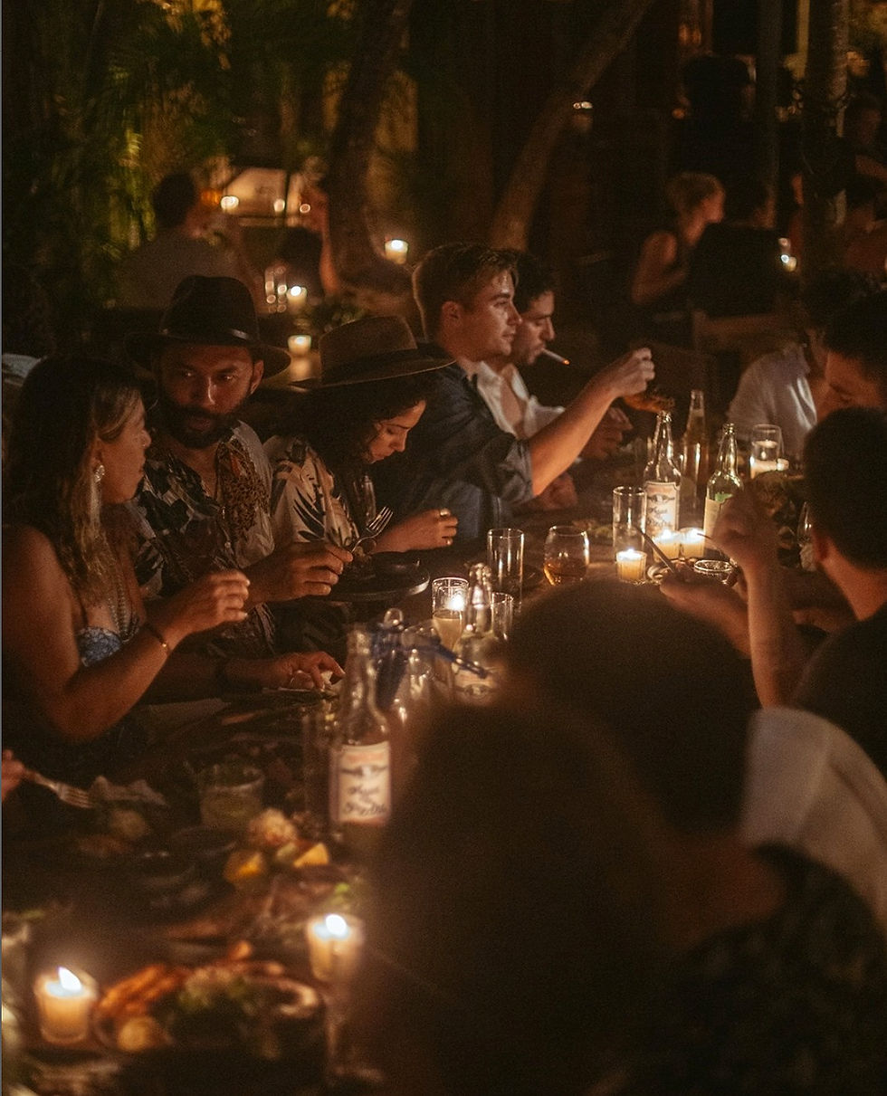 dim candlelight supper with many guests eating and drinking wine at Casa Jaguar bar in the Mayan Riviera