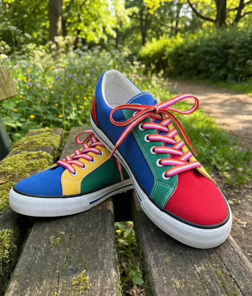 Lesbian Sunset Flag Shoelaces featuring pink, orange, and white stripes inspired by the lesbian pride flag.