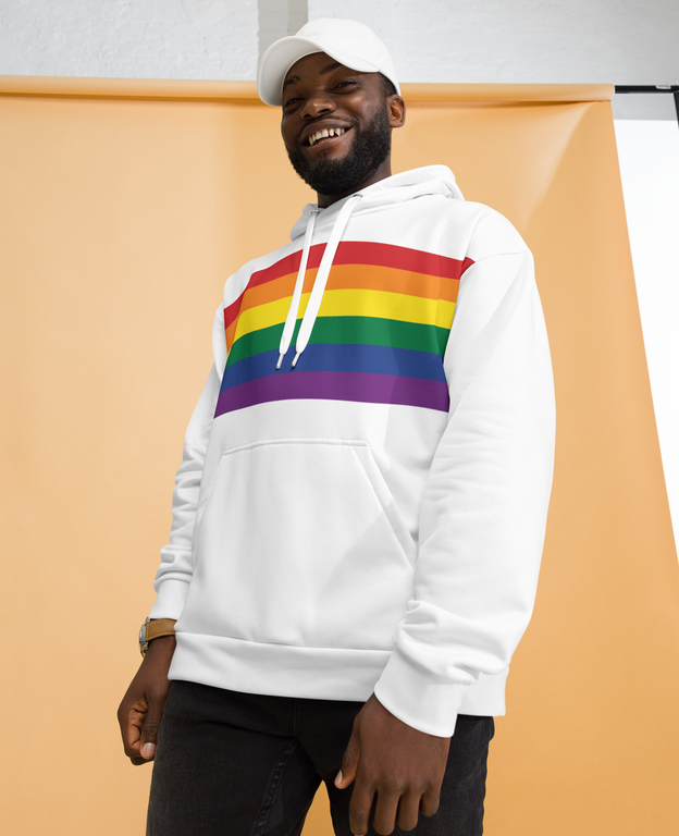 Model wearing a rainbow pride hoodie, showcasing colorful pride stripes.