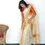 Thumbnail: Merigold Orange Tussel Tissue Setmundu with Blouse model standing view