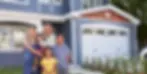 a smiling family posing in front of their pest-free home