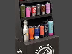 Display of colorful Polar Camel Tumblers on shelves. Text: "High Endurance Drinkware" and "polarcamels.com." Black stand with logo.