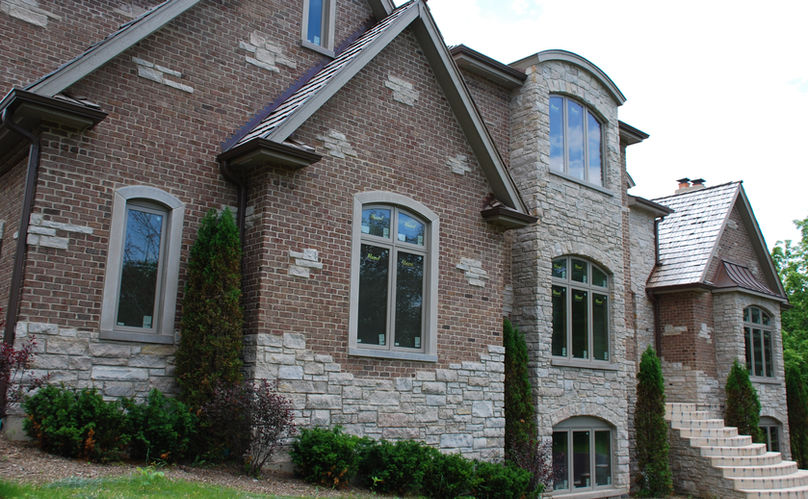 Oakfield Stonegate is a natural machine cut veneer with natural top & bottoms, and random lengths. This 100% splitface architectural stone maintains beige, tan, gray, rustic, and earthtone characteristics. Quarried by Oakfield Stone company, this dolomitic limestone is available in full-bed depth and natural thin stone veneer.