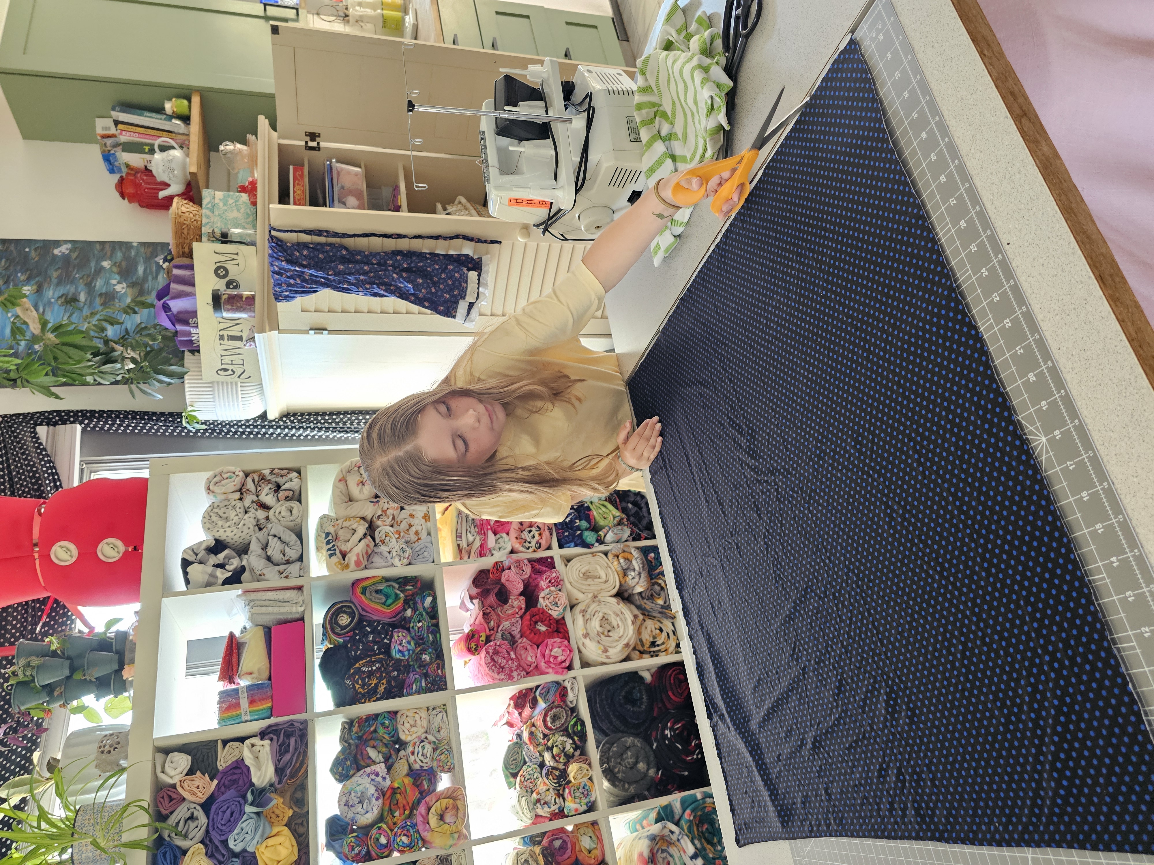 A colorful fashion design project in progress on a professional sewing workspace.