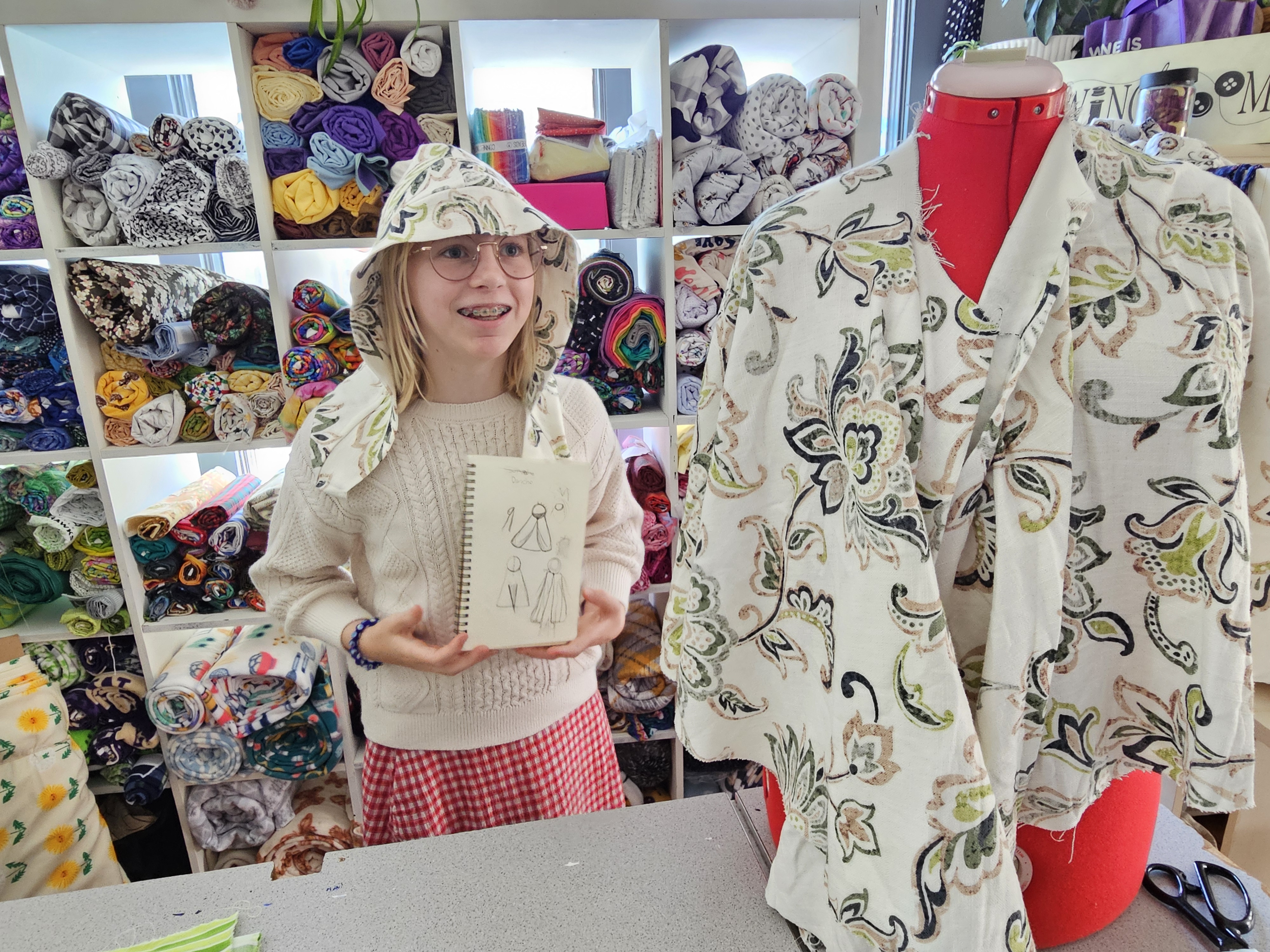 Creative youth hands carefully working on a sewing project with vibrant fabrics and threads.