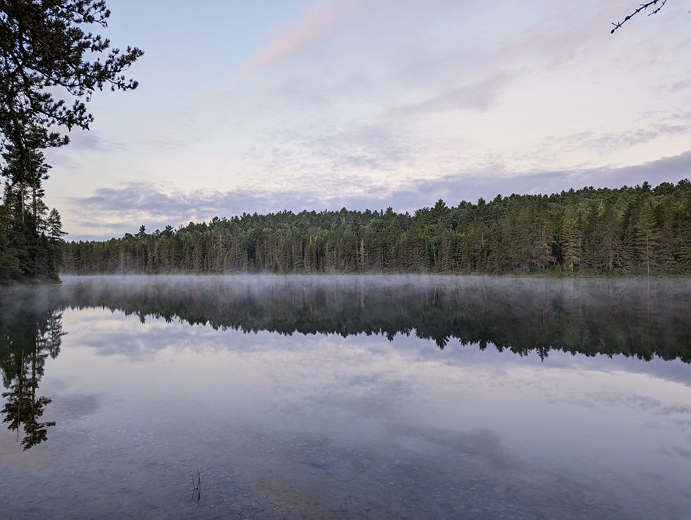 A lake with fog rolling across