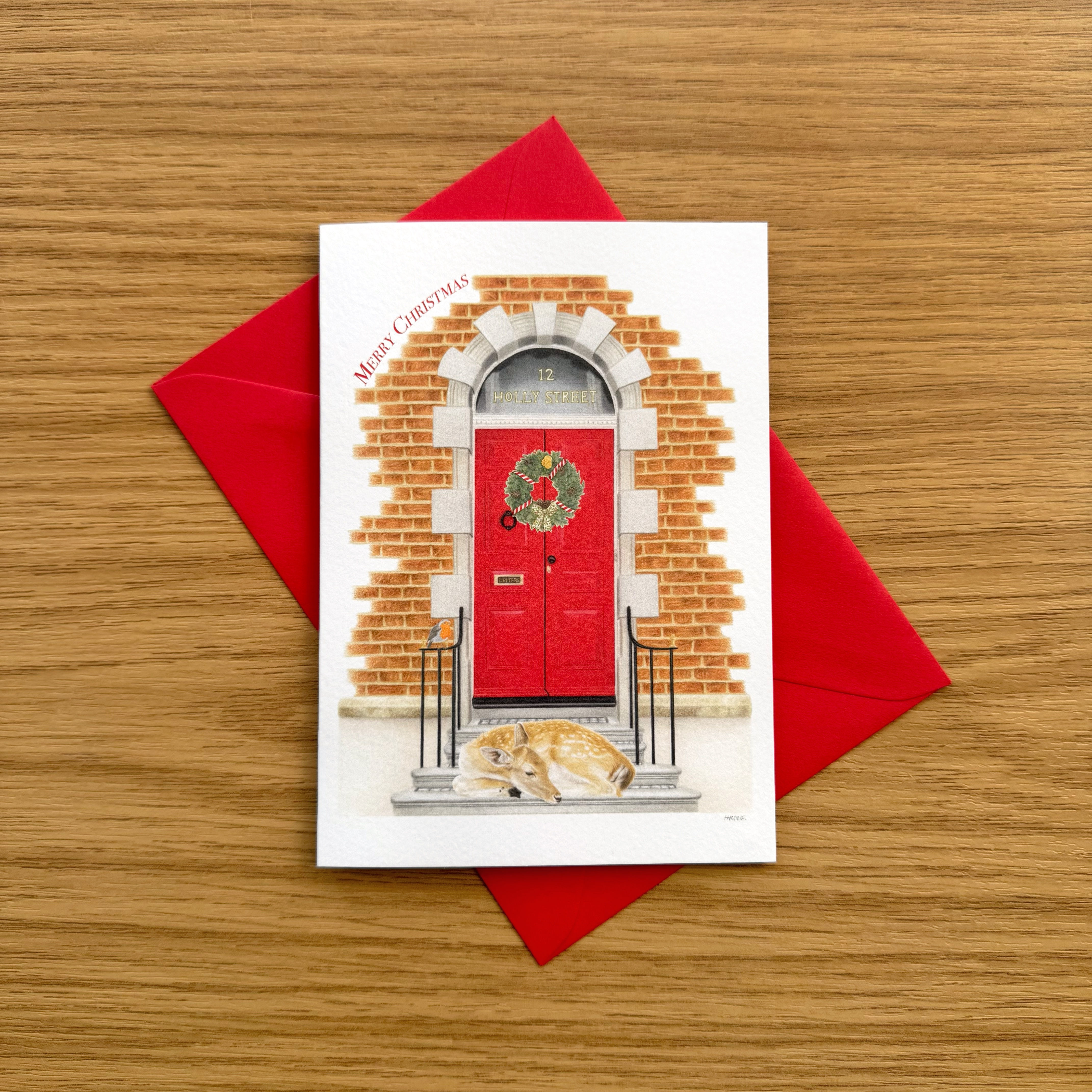 A red door Christmas greeting card, on a red envelope