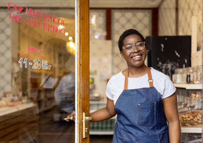 black African woman sales assistant unpacked grocery store Berlin